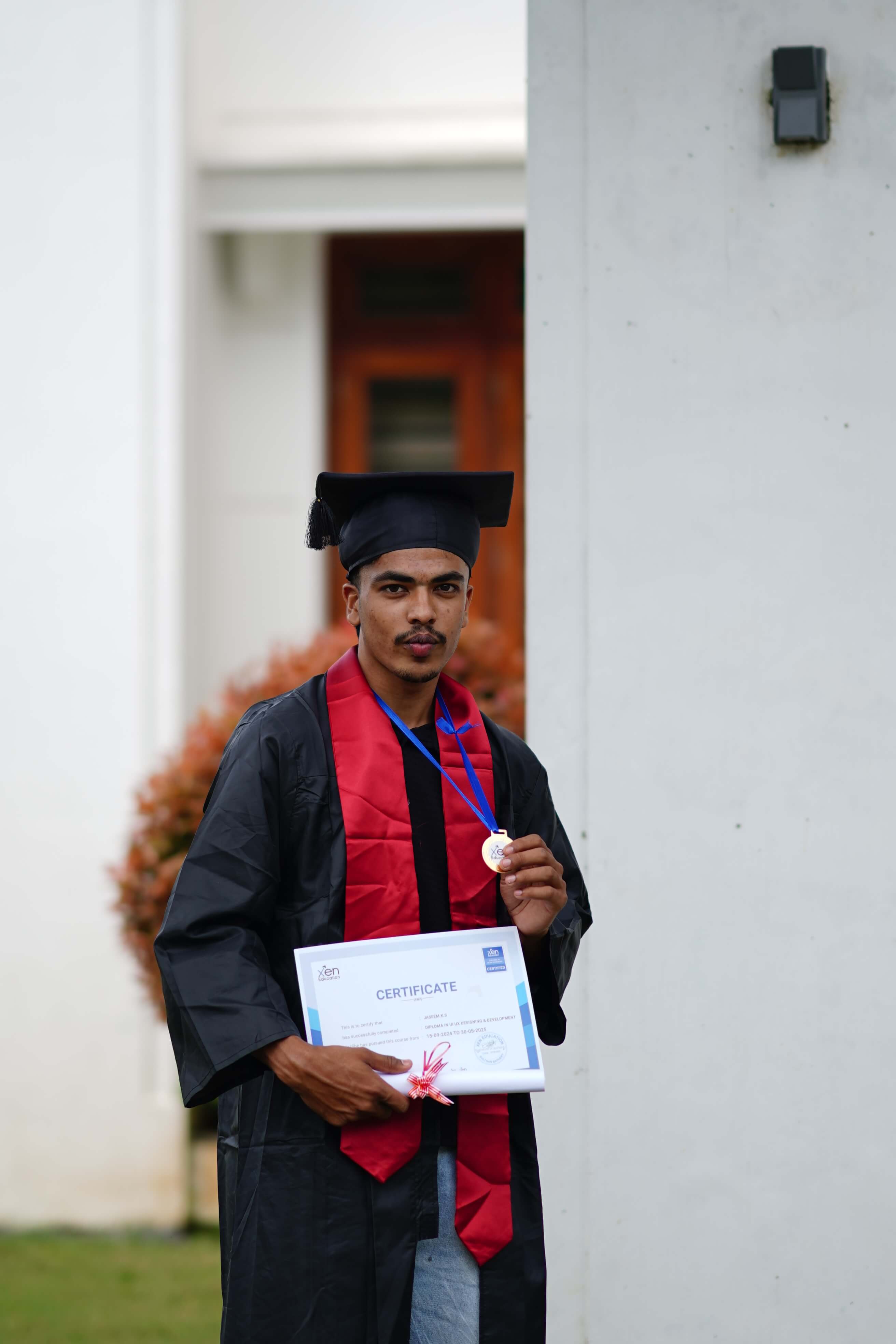 Student receiving a course completion certificate at Xen Coding Academy